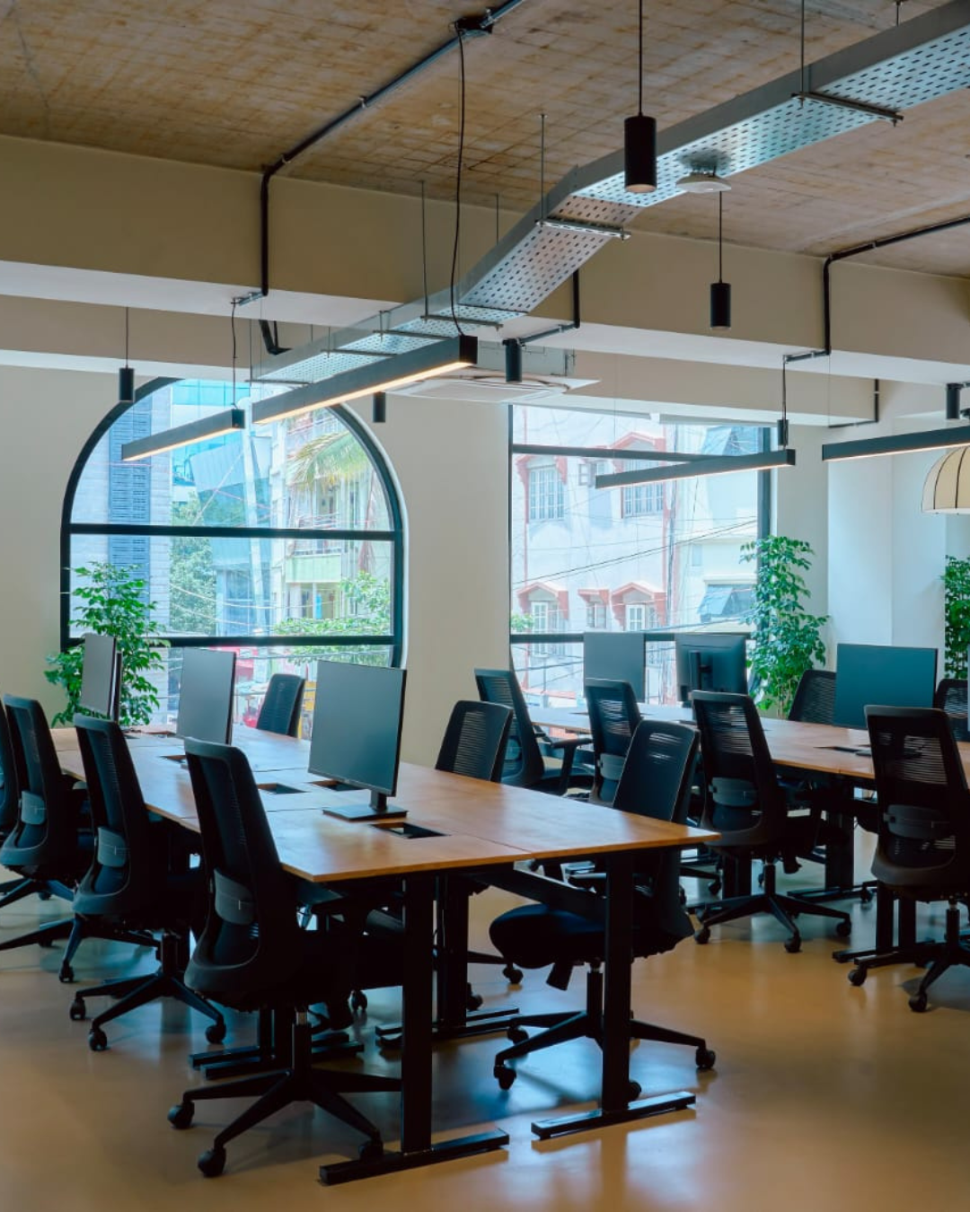 Open-plan managed office workstations with natural light in a Hyderabad business hub