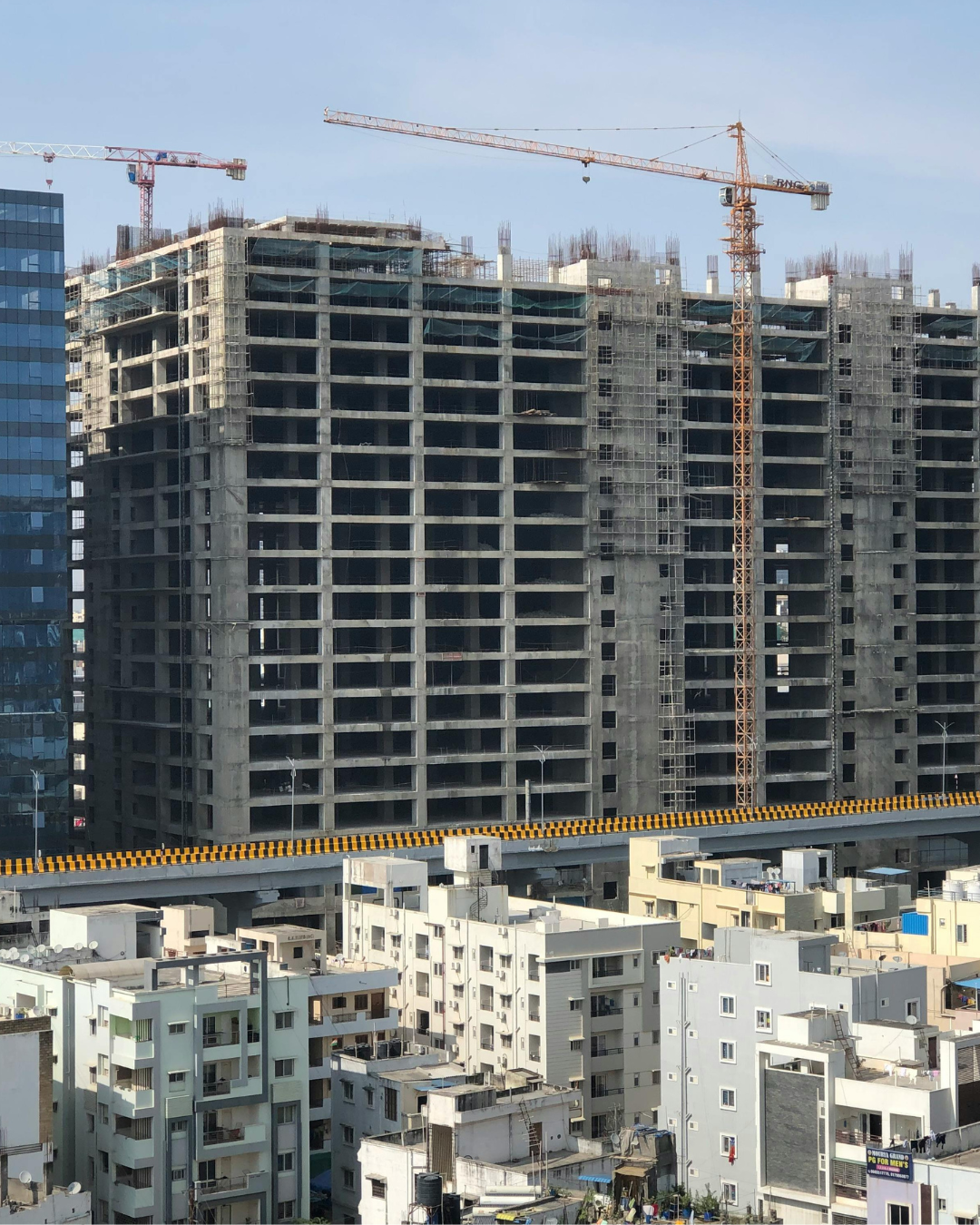 High-rise office and residential towers under construction along Hyderabad's western corridor near Kokapet