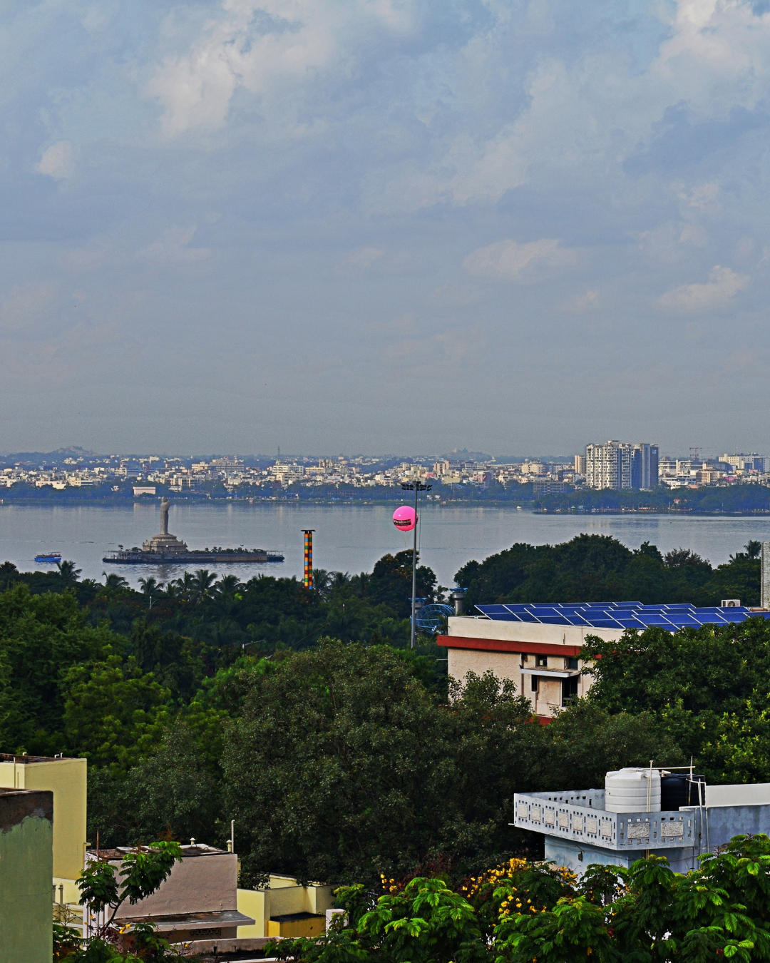 View of Hyderabad's skyline and Hussain Sagar lake, framing the city's expanding business districts