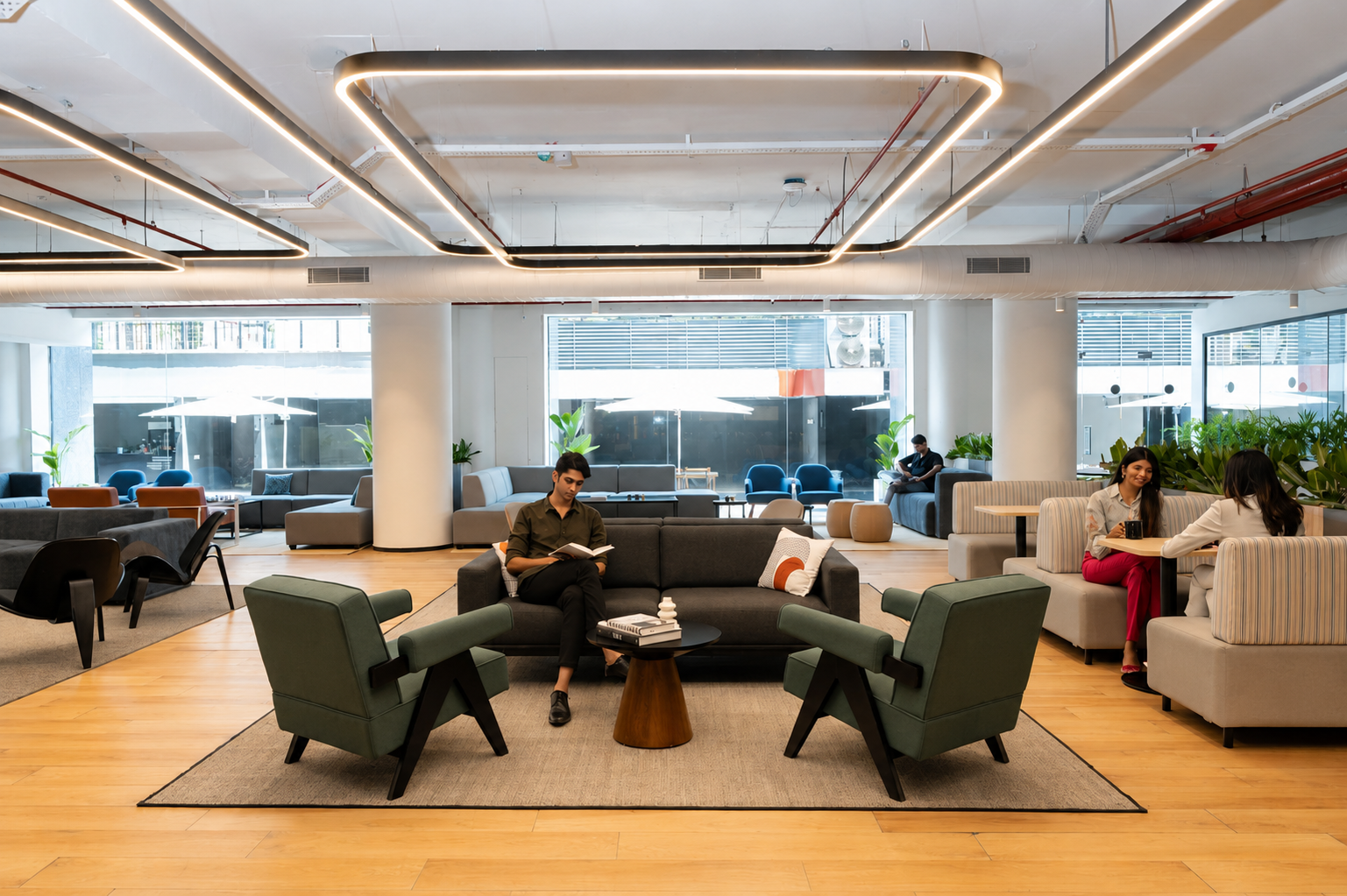 Employees relaxing and working in a managed office lounge and breakout seating area