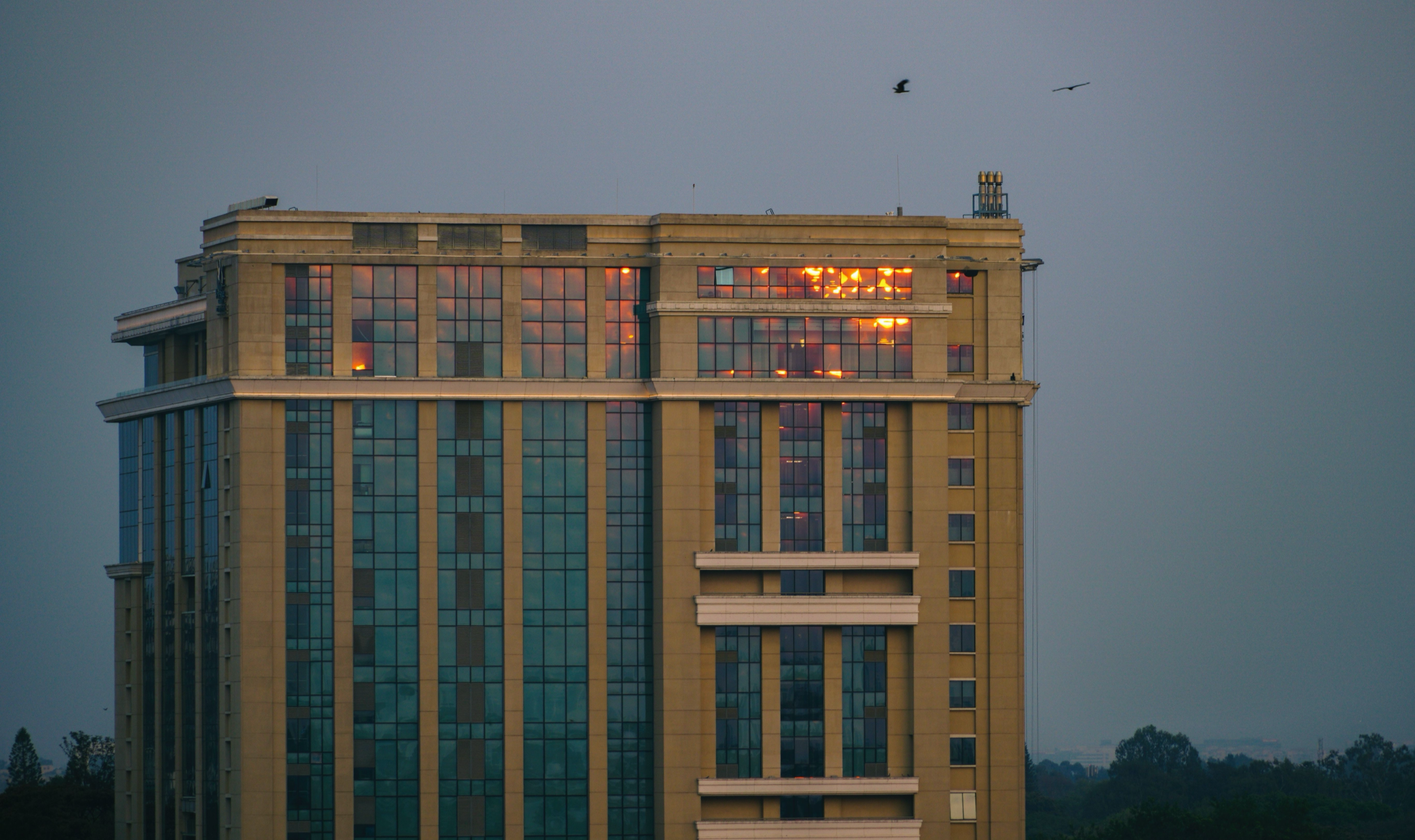 Glass office building in a Bangalore business district at sunset